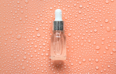 Bottle of cosmetics and drops of liquid, moisturizing. Hyaluronic acid. Selective focus.