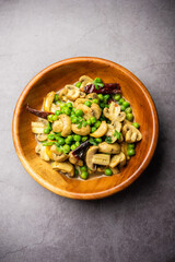 Mushroom and Pea Curry with Roasted Garlic, Indian food served in a bowl