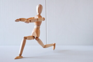 Wooden doll as a model for exercising in a healthy life	
