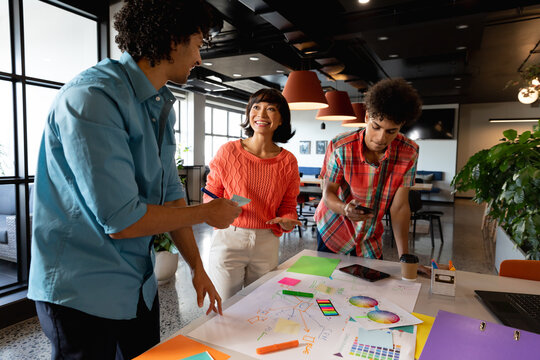 Creative multiracial colleagues planning business strategy in meeting at office