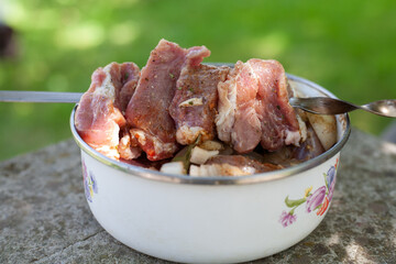 In the pan is cooked meat for barbecue. Sprinkled with spices.