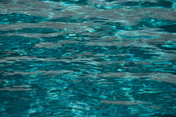 Abstract ripple wave and clear turquoise water surface in swimming pool, blue water wave for background and abstract design.