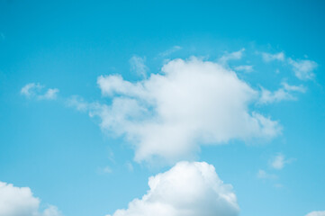 Naklejka na ściany i meble Blue sky with white fluffy clouds Nature background