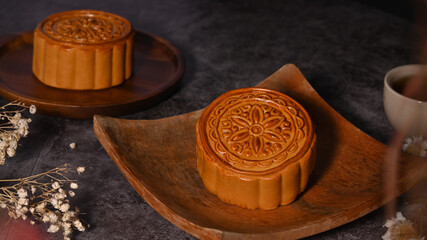 Traditional moon cakes on wooden plate. Chinese mid Autumn festival celebration