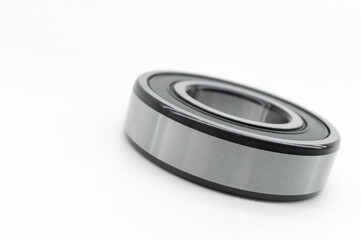 Closed type bearing for modern equipment and machines on a white background. Italian ball bearing with protective covers. Selective focus