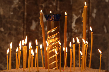 Wax candle burning in the church.