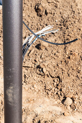Lamppost with open hole. Inside is a power switch and electrical cables. Electrical connection for a lamppost. Installation of street lighting.