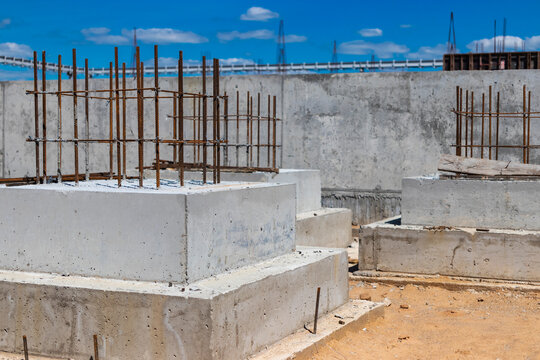 Monolithic reinforced concrete foundations for the construction of a residential building. Grillage at the construction site. Construction pit with foundations.