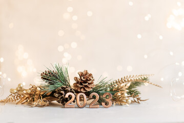 Holiday background Happy New Year 2023. Numbers of year 2023 made by gold candles on bokeh festive...