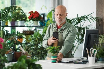 Florist taking pictures of his plants