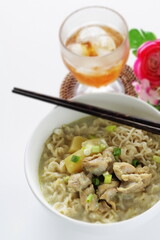 Thai fusion food, green curry ramen noodles and iced tea