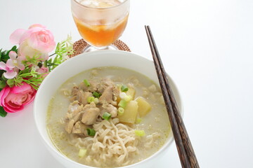 Thai fusion food, green curry ramen noodles and iced tea