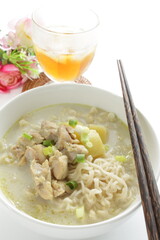 Thai fusion food, green curry ramen noodles and iced tea