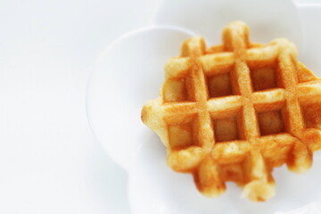 Belgium waffle on white plate for sweet breakfast 