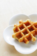 Belgium waffle on white plate for sweet breakfast 