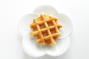 Belgium waffle on white plate for sweet breakfast 