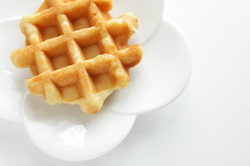 Belgium waffle on white plate for sweet breakfast 