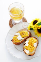 Boiled Japanese sweet corn and cream cheese on French bread toasted for summer healthy breakfast