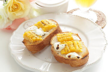 Boiled Japanese sweet corn and cream cheese on French bread toasted for summer healthy breakfast