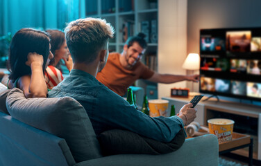 Friends watching movies together at home - obrazy, fototapety, plakaty