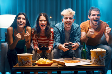 Cheerful friends playing video games together