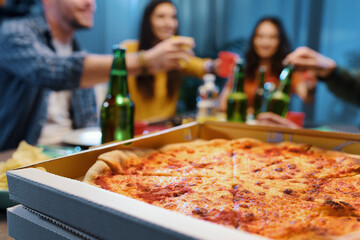 Friends eating pizza together at home