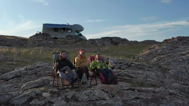  Family spending time together on vacation near modern rv camper van.