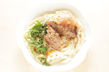 Homemade hamburger patty in half on Japanese udon noodles for comfort food image