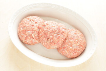 Prepared hamburger patty for cooking image