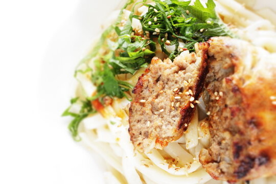 Homemade hamburger patty in half on Japanese udon noodles for comfort food image