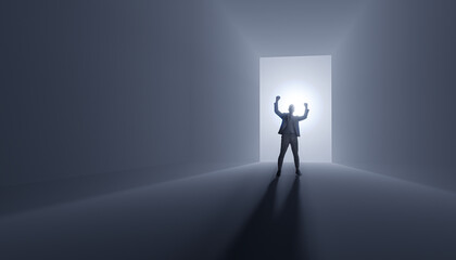 Businessman success - cheers success with raised hands against the background of light breaking through the door - concept of human success