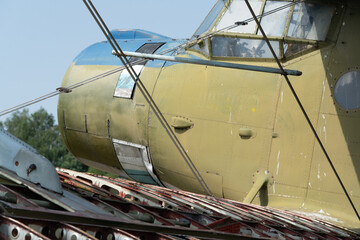 A close-up photo of an old broken biplane airplane