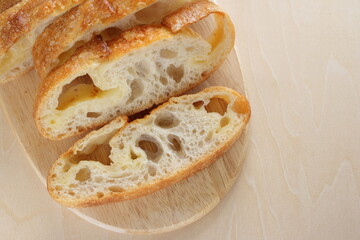 Sliced French bread on wooden board with copy space