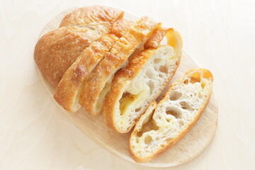 Sliced French bread on wooden board with copy space