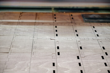 Laser cutting beam over plywood sheet