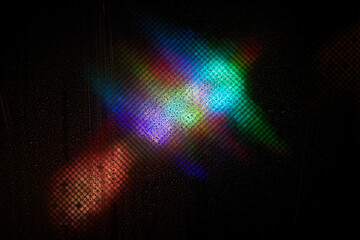 Holographic rainbow multicolor light. Glares with a spectral gradient on a dark background....