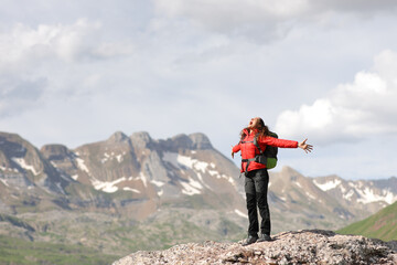 Excited hiker outstretching arms screaming in a high mountain