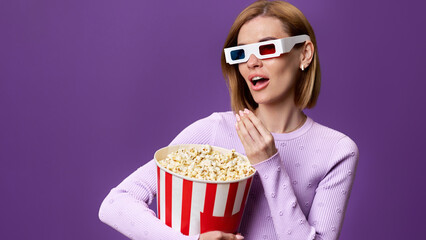 woman watching movie film, holding bucket of popcorn