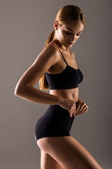 Obraz premium Young attractive sexy woman in lingerie isolated on gray background