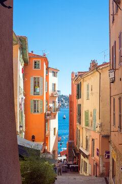 Fototapeta Villefranche-sur-Mer, France, September 2021. Old narrow authentic street of the city of Villefranche-sur-Mer in the French Riviera resort. Journey along the Cote d'Azur.