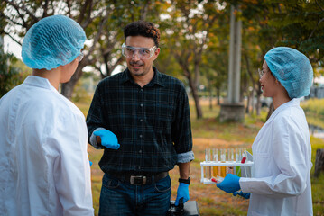 Scientists team collect water samples for analysis and research on water quality, environment with saving earth.