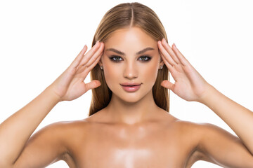 Fototapeta premium Young pretty woman touching her face isolated on white background