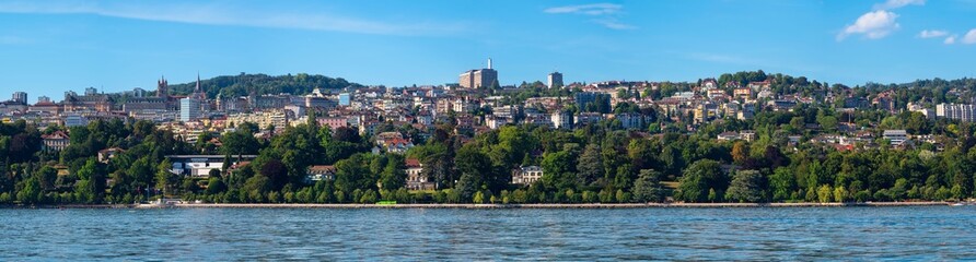 Fototapeta na wymiar Lausanne, Switzerland - July 14, 2022: The cityscape of Lausanne at the Geneva lake, the capital and the largest city of canton Vaud in Switzerland