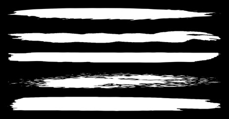 A set of vector brushes in grunge style. White paint strokes with a dry brush on a black background