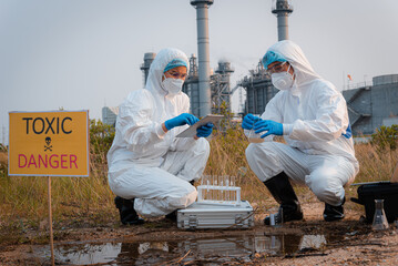 Ecologist taking samples of water with test tube from city river to determine level of contamination and pollution, Research conserve water and environment.
