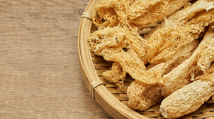 close up dry bamboo mushroom or on bamboo fungus wooden plate on wood table background                                                       