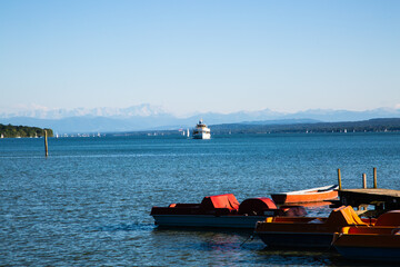 Fototapeta premium Ammersee in summer, with pedal boats and steamboat