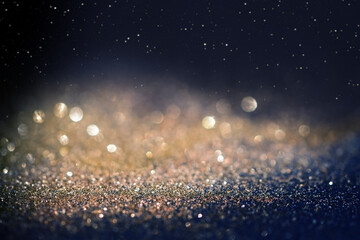 Defocused White and gold Lights Over Dark Background with thin focus line and copy space