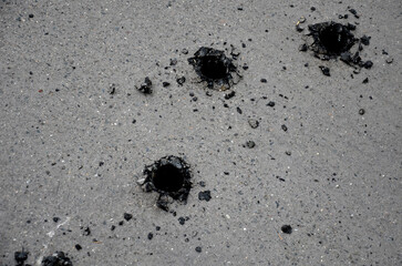 shot asphalt roads from machine guns, rockets, cluster bombs, or ordinary repairs of utility...