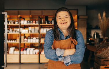 Happy woman with Down syndrome standing in front of a deli